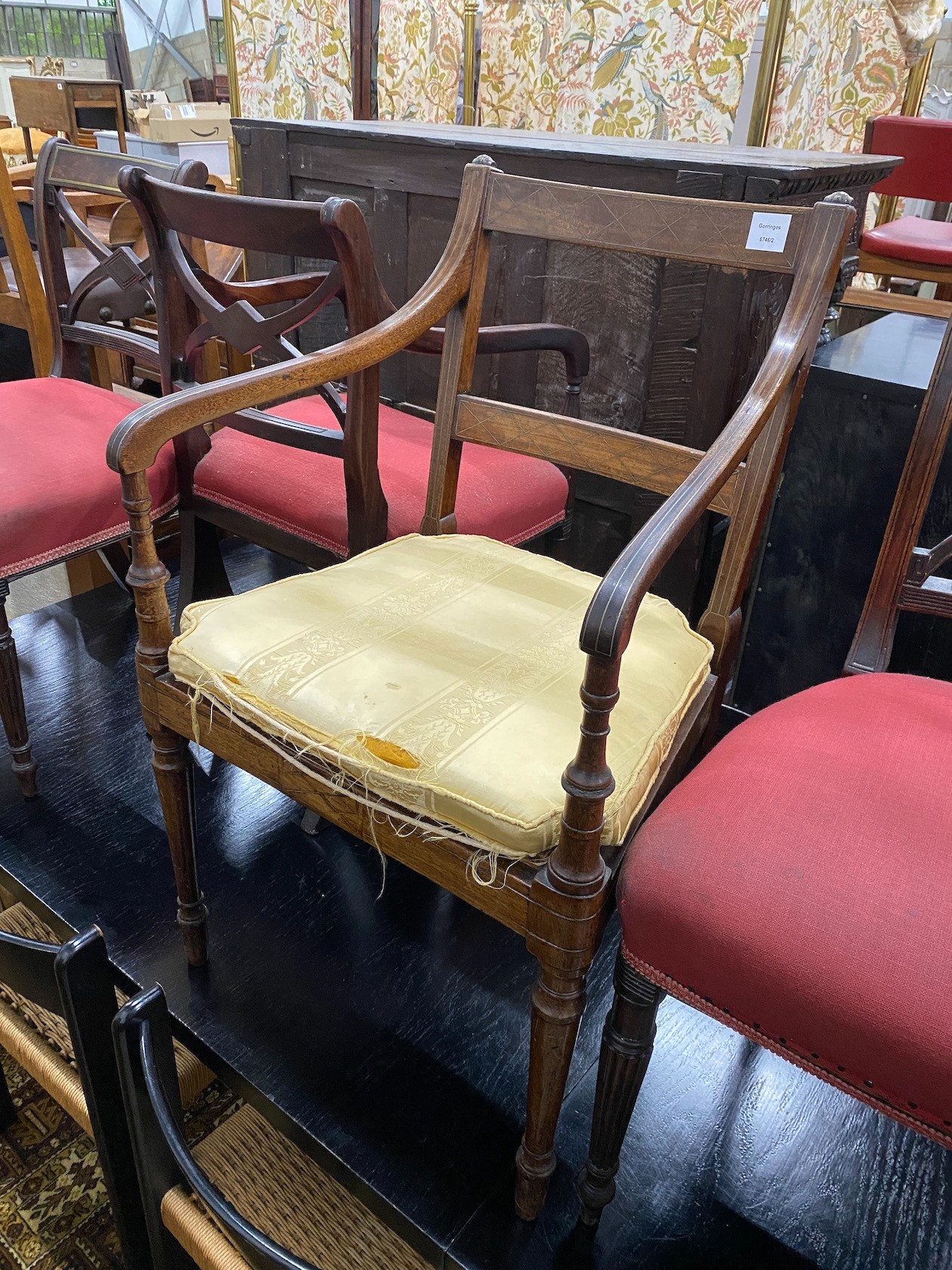 Four Regency brass inlaid mahogany dining chairs one with arms, together with a Regency caned seat elbow chair.